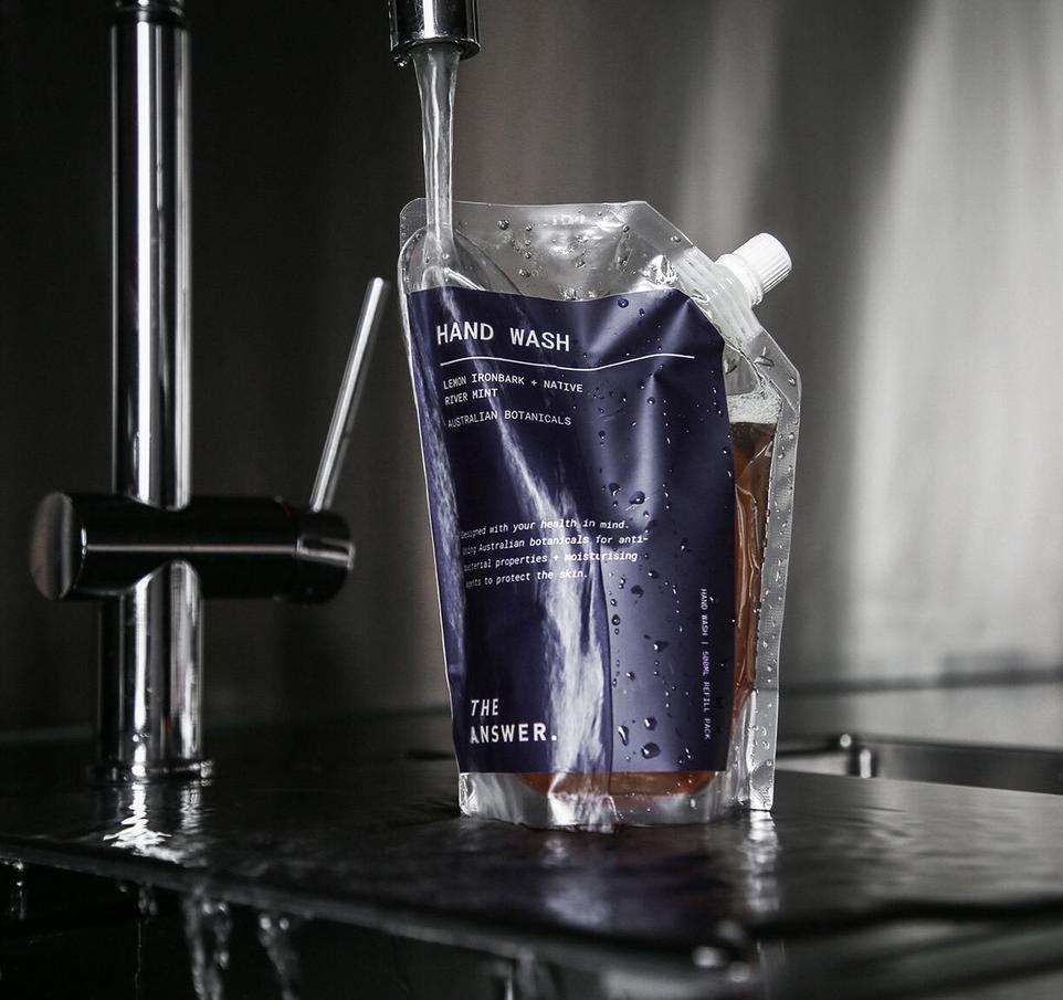 50 ML hand wash product image 3 - Hand wash pouches of varying quantities being placed at The Answer's store